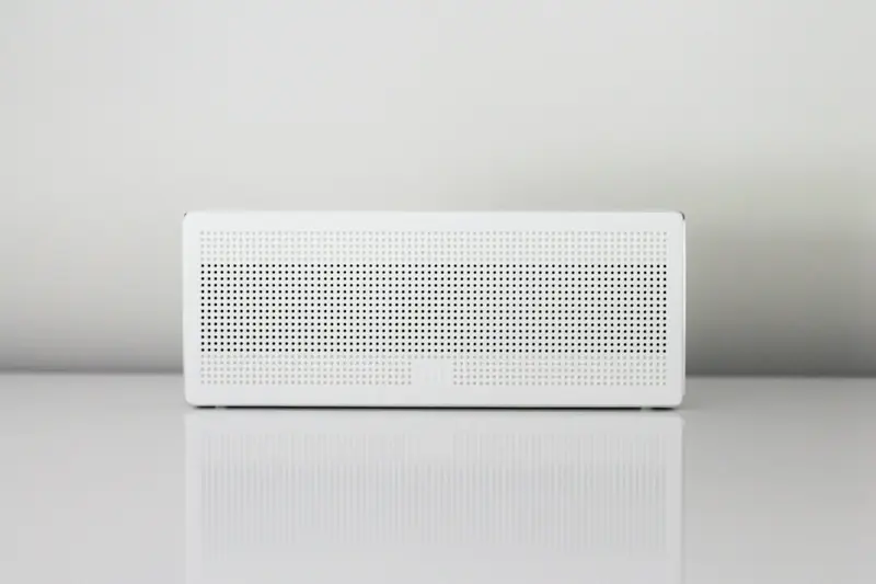 A white dehumidifier on a table against a white wall